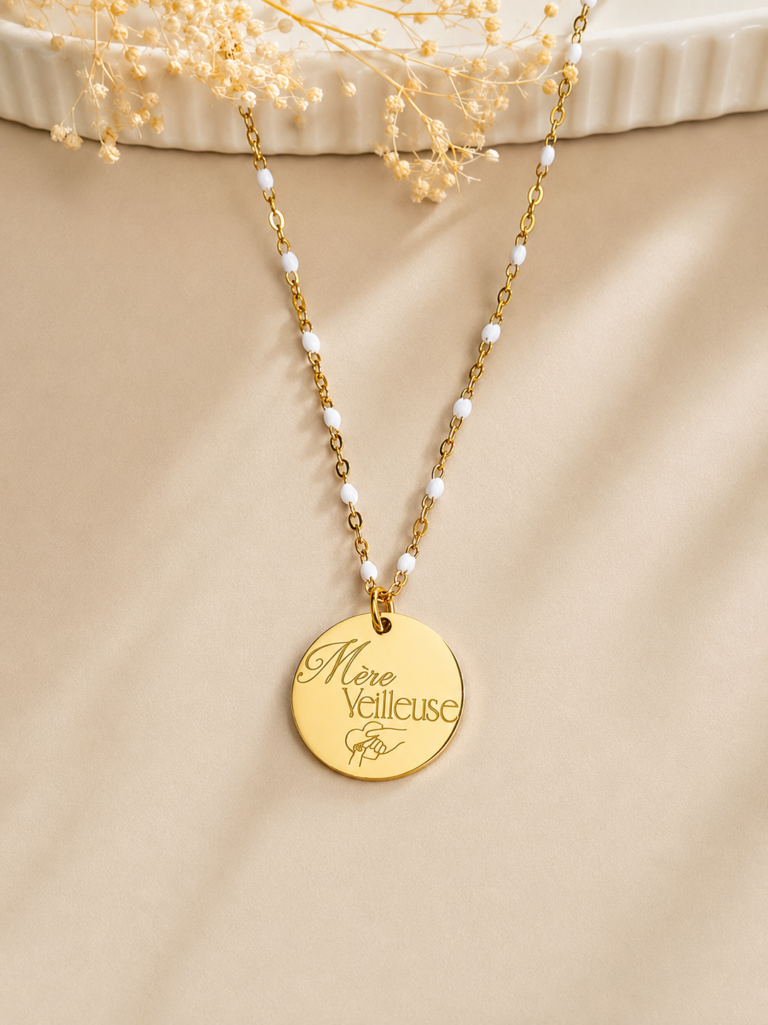     Détail du collier Alma en résine blanche avec médaille personnalisable